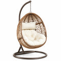Sillón colgante de ratán sintético con cojín crema y estructura metálica